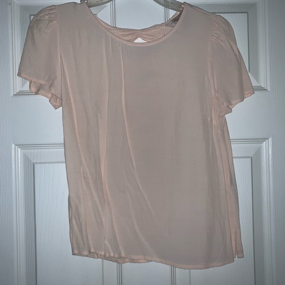 Light pink blouse with bows running down the back